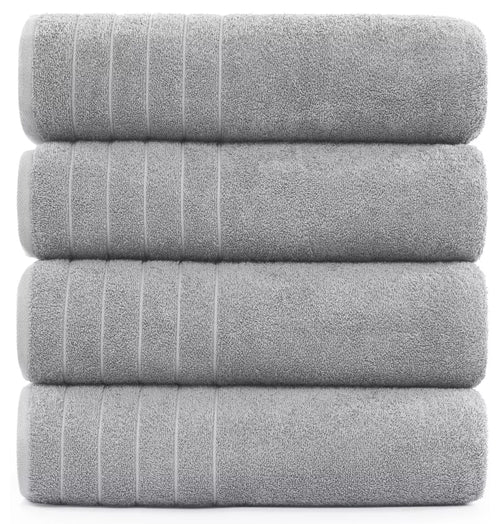 Spa-like experience with a white 600-GSM bath sheet and candles